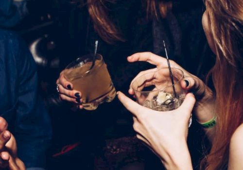 People are enjoying drinks and laughing, possibly at a social event or party.